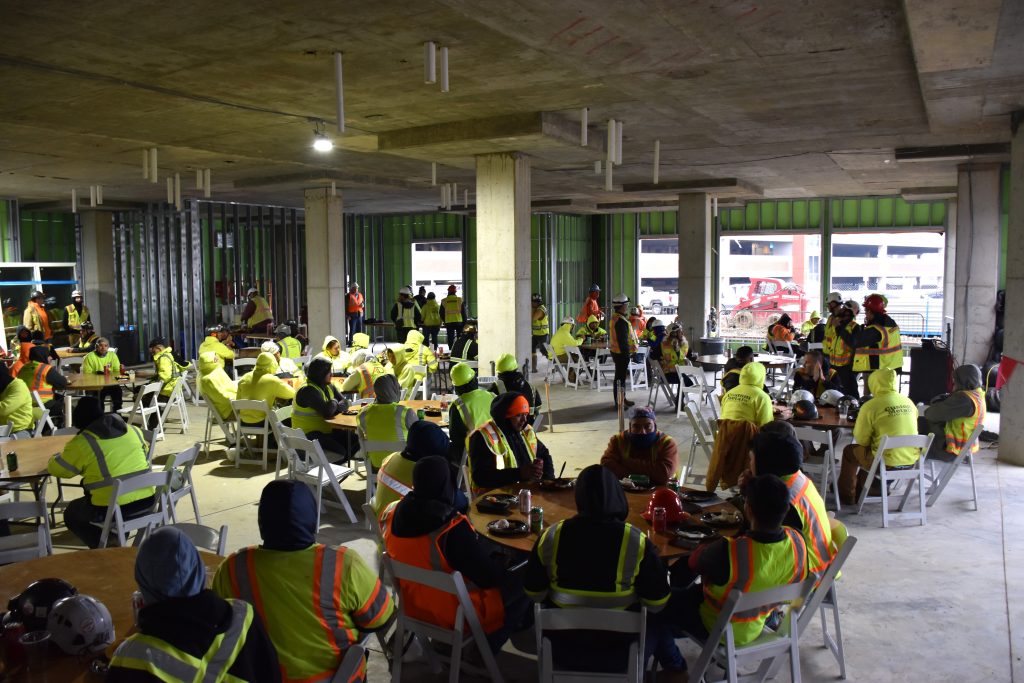 Trade partners celebrate the Aura topping out while having lunch.