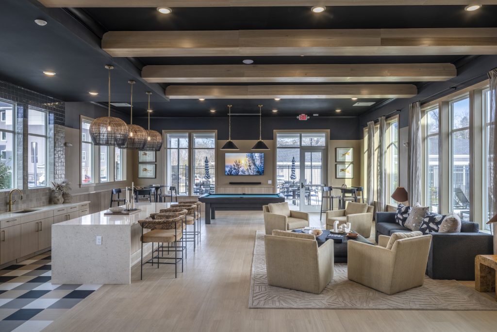 Clubhouse seating area at Canopy on Western Apartments with lounge seating and a pool table.