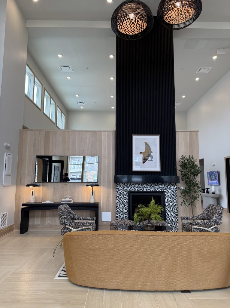 Floor to ceiling decorative fireplace inside the clubhouse at Canopy on Western Apartments.